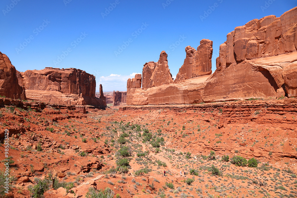 Arches National Park, Utah:: The Park Avenue Formation and trail. The sizes of the formations can be seen when compared to the miniscule size of the hikers on the trail. Arches National Park, Utah:: The Park Avenue Formation and trail. The sizes of the formations can be seen when compared to the miniscule size of the hikers on the trail.