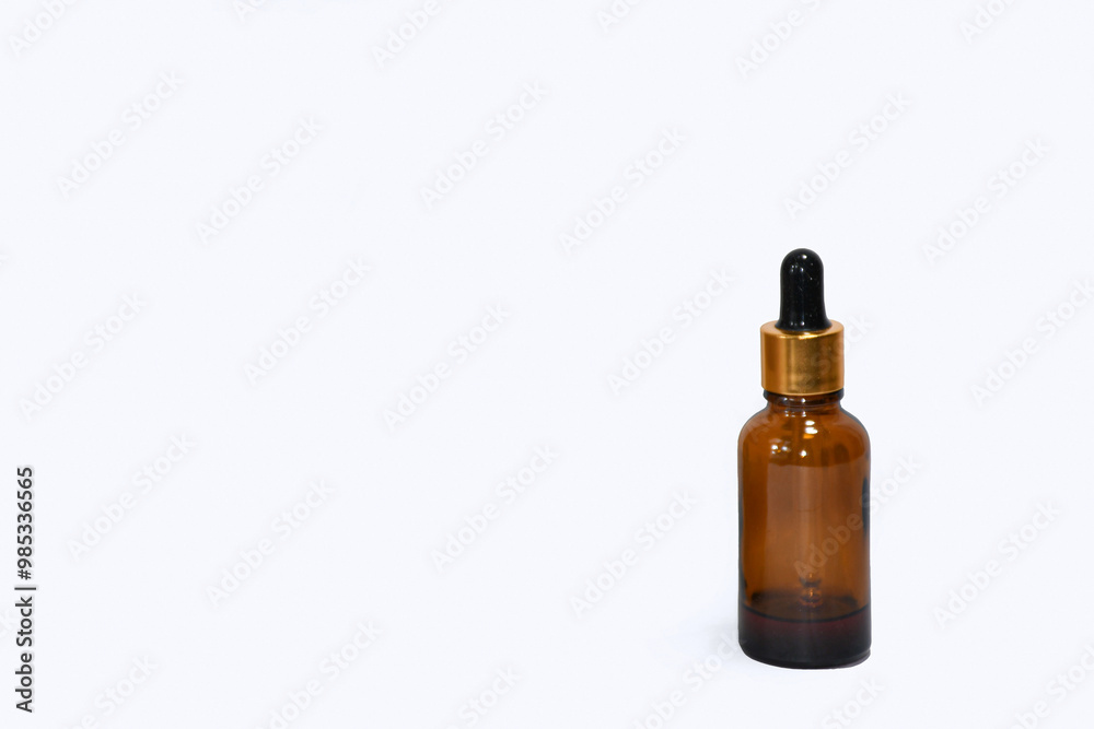 Massage oil Bottle of homeopathy Medicine closeup, Cosmetic dropper bottle on white background, homeopathic healthcare, treatment oil, isolated white background, Concept of alternative herbal medicine Massage oil Bottle of homeopathy Medicine closeup, Cosmetic dropper bottle on white background, homeopathic healthcare, treatment oil, isolated white background, Concept of alternative herbal medicine
