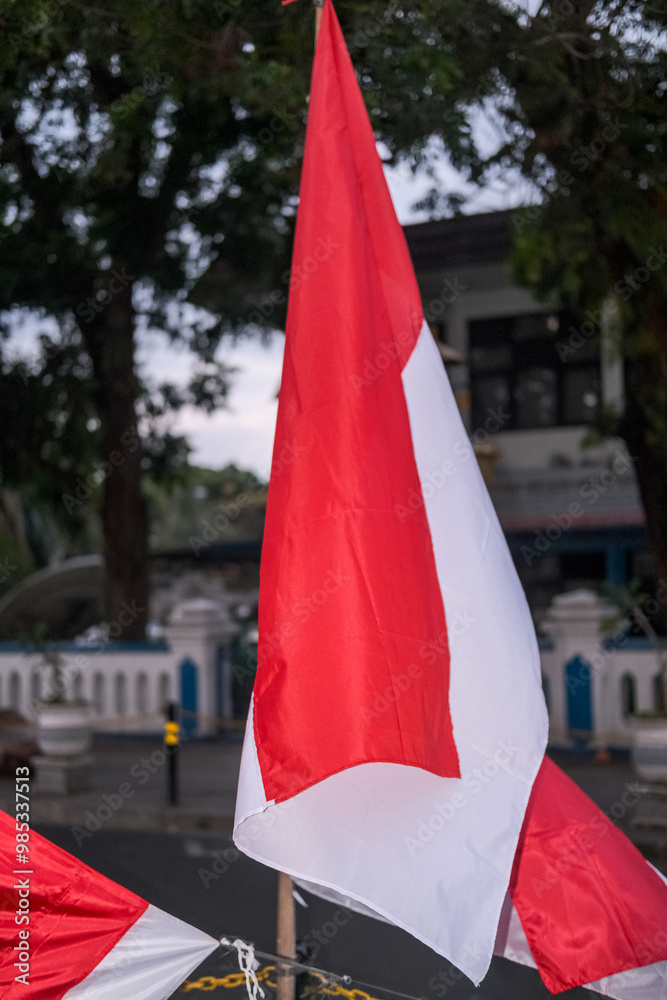Many red and white Indonesian flags are sold along the roadside in August, symbolizing the spirit of independence and national pride celebrated every year.