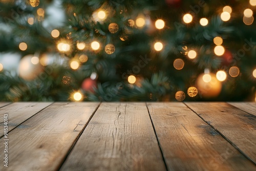 Close up of a rustic wooden surface with a blurred Christmas tree and lights in the background.