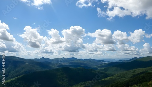 Wallpaper Mural Imagine a summer day in the mountains with fluffy white cumulus clouds dotting the bright blue sky, casting playful shadows on the lush green valleys below 4 Torontodigital.ca