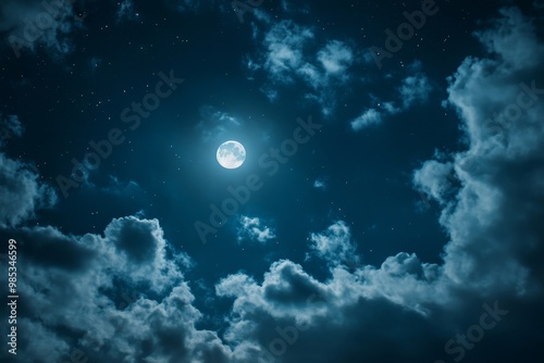 Fototapeta Naklejka Na Ścianę i Meble -  A bright full moon shines through fluffy clouds in a night sky filled with stars.