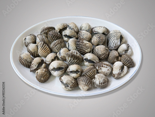 Boiled granular arks in a white dish, South Korea 