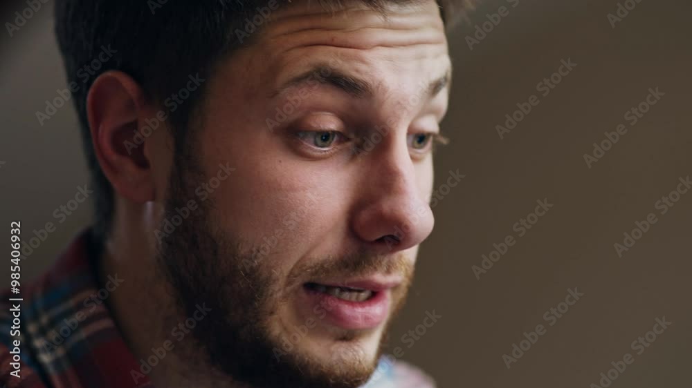 Close up portrait of young man having troubles with internet connection, looking at screen and shaking head in despair, slow motion Close up portrait of young man having troubles with internet connection, looking at screen and shaking head in despair, slow motion