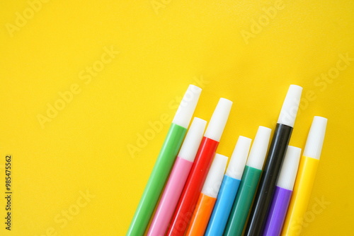Colorful Markers on a Yellow Background