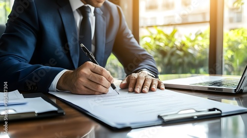 Businessman Signing Formal Business Document at Corporate Desk