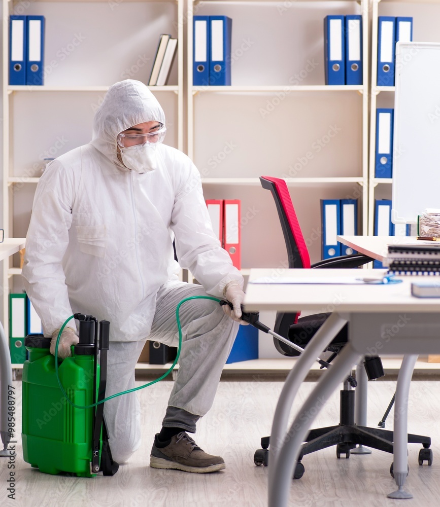 Professional contractor doing pest control at office