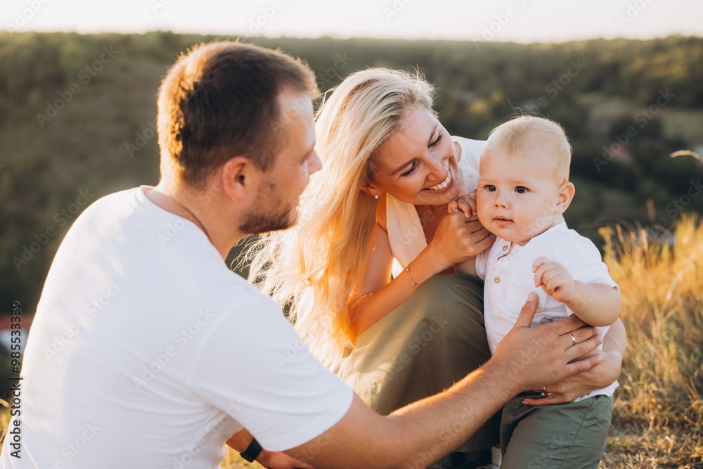 Happy Family Enjoying Quality Time Outdoors with Their Young Child in Nature Happy Family Enjoying Quality Time Outdoors with Their Young Child in Nature