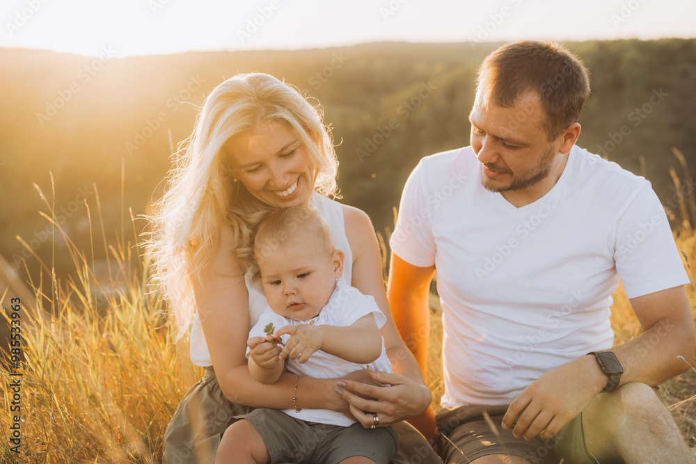 Fototapeta premium Happy Family Enjoying a Beautiful Sunset Outdoors in a Natural Setting