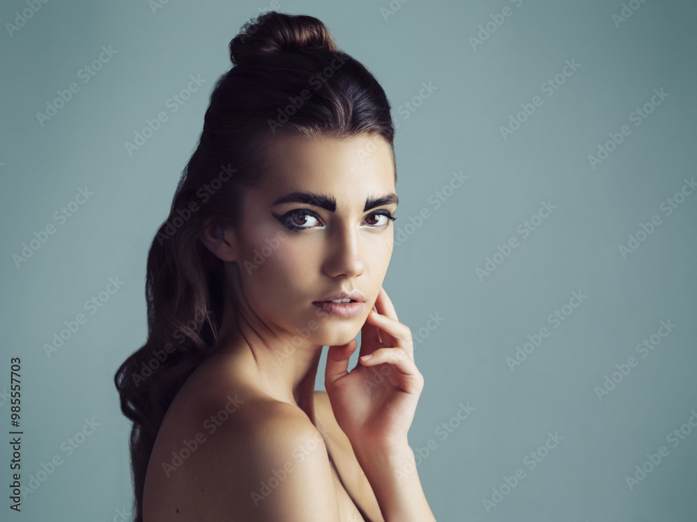 Makeup, beauty and portrait of woman in studio with mockup space for facial cosmetics routine. Confident, creative and serious young female person with face cosmetology isolated by gray background. Makeup, beauty and portrait of woman in studio with mockup space for facial cosmetics routine. Confident, creative and serious young female person with face cosmetology isolated by gray background.
