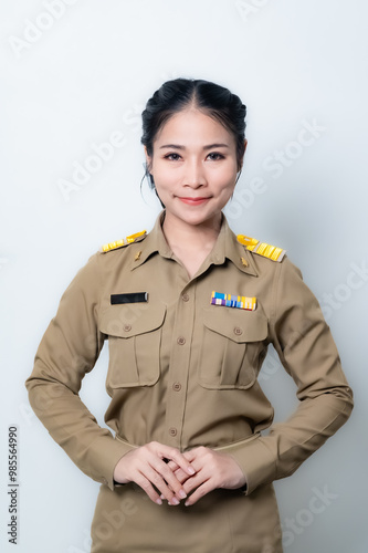 Female Thai government officer in khaki uniforms smiling. Beautiful woman doing winner gesture with arms raised isolated over white background. Concept