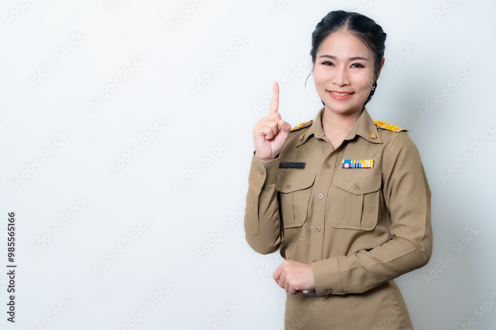 Female Thai government officer in khaki uniforms smiling. Beautiful woman doing winner gesture with arms raised isolated over white background. Concept Female Thai government officer in khaki uniforms smiling. Beautiful woman doing winner gesture with arms raised isolated over white background. Concept