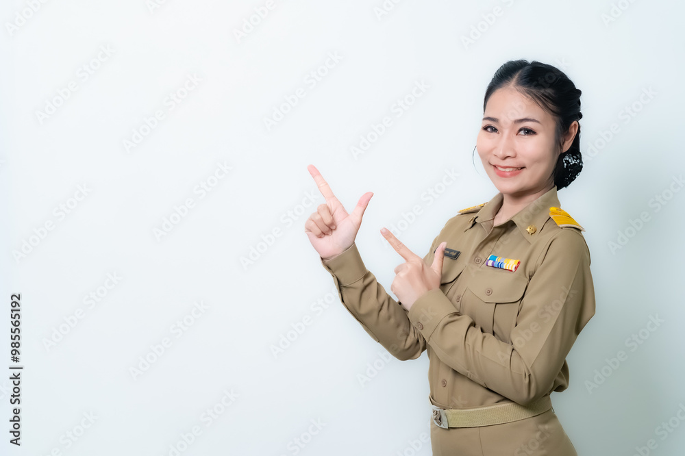 Female Thai government officer in khaki uniforms smiling. Beautiful woman doing winner gesture with arms raised isolated over white background. Concept Female Thai government officer in khaki uniforms smiling. Beautiful woman doing winner gesture with arms raised isolated over white background. Concept