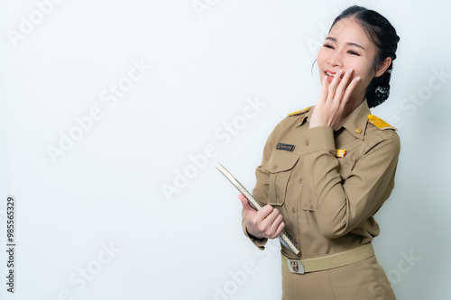 Female Thai government officer in khaki uniforms smiling. Beautiful woman doing winner gesture with arms raised isolated over white background. Concept