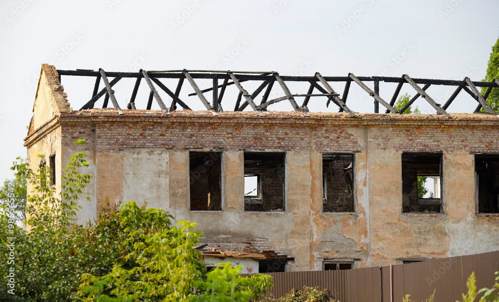 A building with a lot of windows and a roof that is missing A building with a lot of windows and a roof that is missing