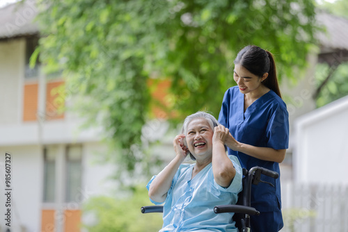 Smiling Elderly Woman in a Wheelchair Enjoying Time with a Caring Nurse Outdoors, Highlighting Compassionate Care and Joyful Moments photo