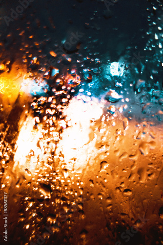 Bild auf Leinwand Water drops on the glass of the evening city