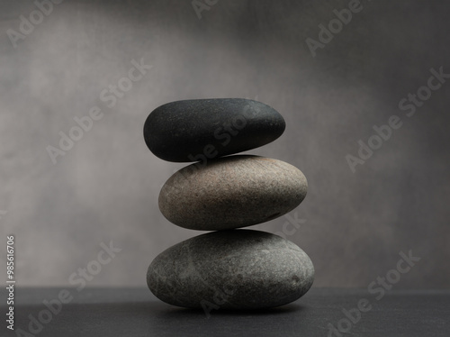 real stones in stack with texture for podium background product presentation.three zen stones natural on gray background for cosmetic podium background