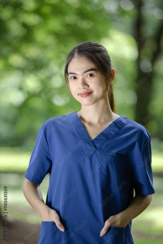 Confident Young Nurse in Blue Scrubs Standing Outdoors, Highlighting Professionalism and Compassionate Care Confident Young Nurse in Blue Scrubs Standing Outdoors, Highlighting Professionalism and Compassionate Care