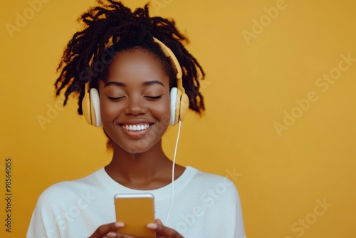 Beautiful African American woman listening to music on phone.