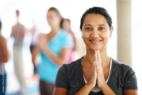 Woman, portrait and trainer at yoga class, namaste and group for meditation in spiritual position. Person, yogi teacher and instructor for mindfulness at studio, support healing and fitness in India