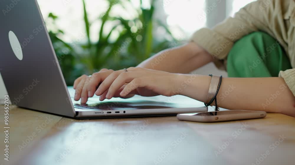 Close-up shot of woman's hands typing on a laptop keyboard Close-up shot of woman's hands typing on a laptop keyboard