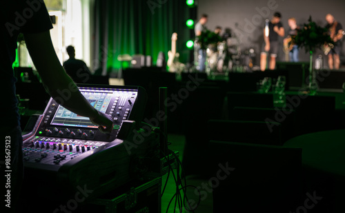 Sound engineer working backstage while preparing audio equipment for a live concert