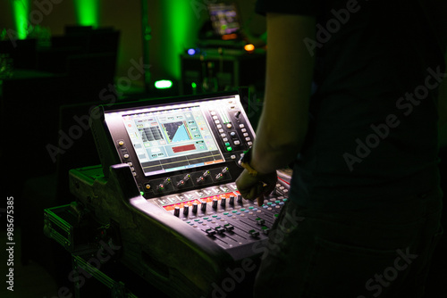 Obraz na płótnie Sound engineer working backstage while preparing audio equipment for a live concert