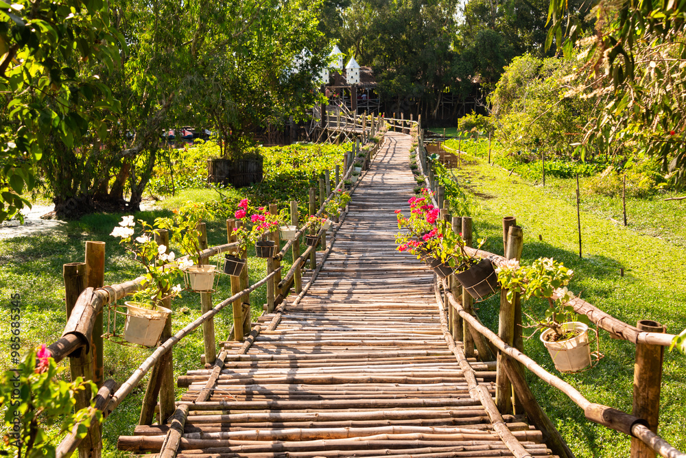 Wooden bridge in Vietnam among green tropical plants Wooden bridge in Vietnam among green tropical plants