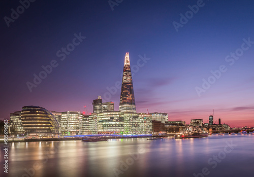 The skyline of The Shard, old City Hall, and the HMS Belfast taken at sunset