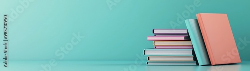 A stack of colorful books on a vibrant turquoise background, perfect for educational, reading, or library themes.