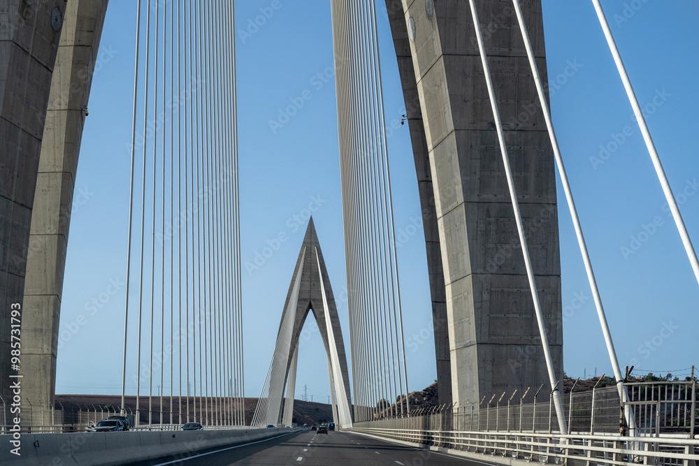 Obraz premium Detail of the Mohamed VI cable-stayed bridge over the Bouregreg river, or oued Bouregreg. Perfect blue sky.