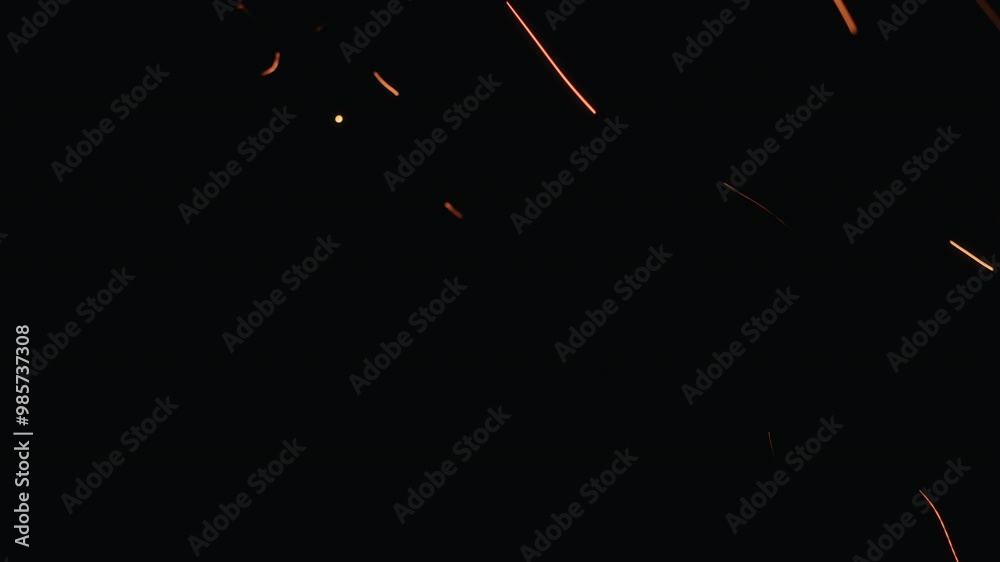 Slow motion hot sparks falling from above black background, 60fps