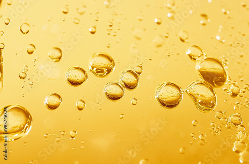 close up of yellow oil bubbles in liquid photo