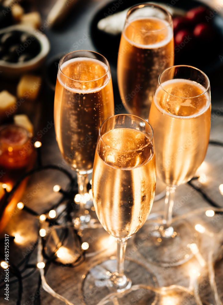 Glasses of sparkling wine or champagne served on the table for Christmas or New Year eve celebration.