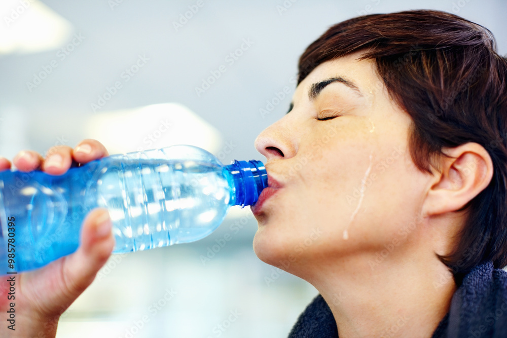 Fitness, sweat or woman drinking water in gym for health, wellness or nutrition with face profile. Tired, liquid or thirsty athlete with bottle for hydration on break after exercise, sport or workout Fitness, sweat or woman drinking water in gym for health, wellness or nutrition with face profile. Tired, liquid or thirsty athlete with bottle for hydration on break after exercise, sport or workout