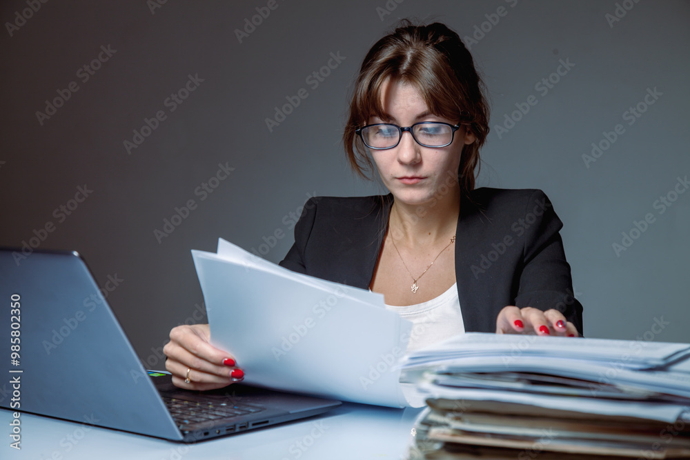 Portrait of female employee working with documents. High salaries, career development, prospects. Horizontal image. Portrait of female employee working with documents. High salaries, career development, prospects. Horizontal image.