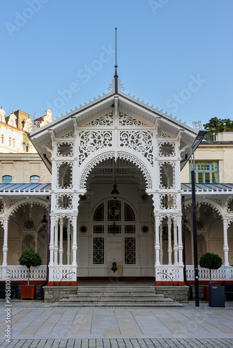 Karlovy Vary, Czech Republic - August 12 2024: Market Colonnade Trzni Kolonada buildt in White Wood in the Swiss Style. photo