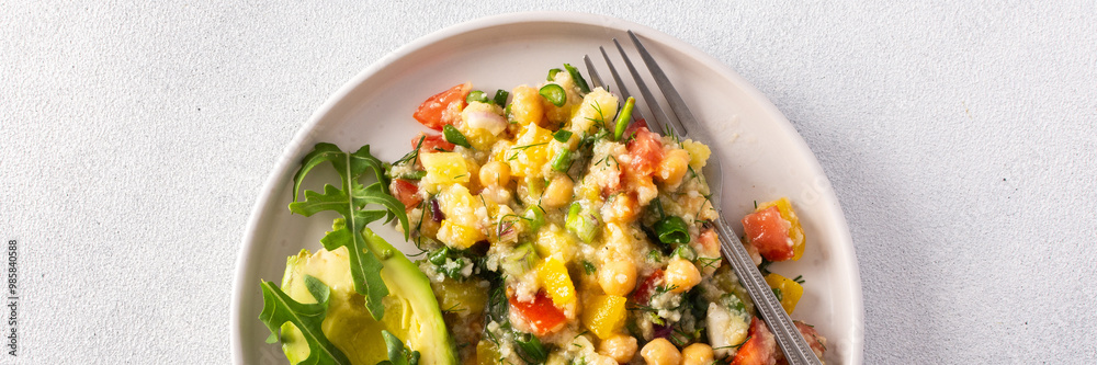A vibrant vegetarian salad featuring boiled millet, chickpeas, fresh vegetables, and avocado, drizzled with olive oil for a delicious and healthy meal, banner A vibrant vegetarian salad featuring boiled millet, chickpeas, fresh vegetables, and avocado, drizzled with olive oil for a delicious and healthy meal, banner
