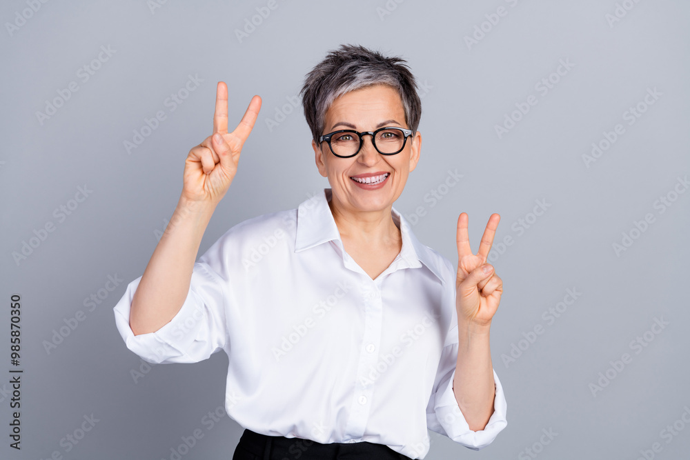 Photo of classy aged corporate woman show v-sign wear shirt isolated on grey color background