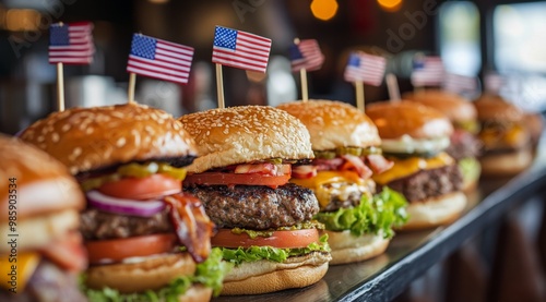 A variety of regional American burgers are arranged on a long table, complete with toothpicks shaped like the flags of each state.