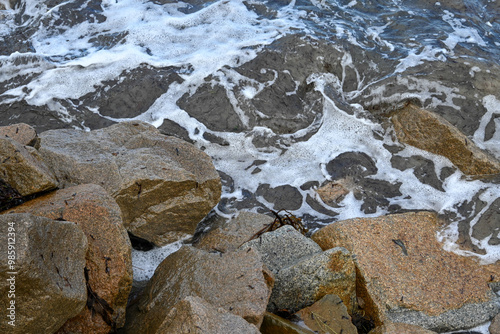 Sea tide over rocks on the beach 