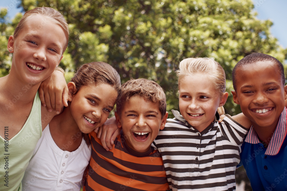 Obraz premium Children, hugging and smile of student friends outdoor at school together for development. Diversity, scholarship or smile with boy and girl kids embracing on playground for learning or study