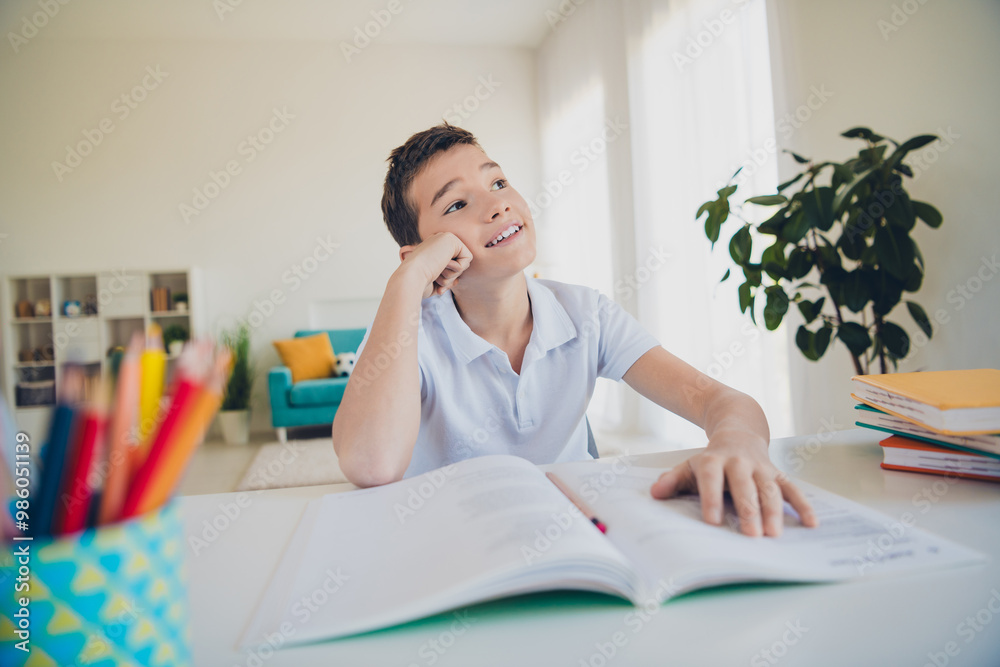 Portrait of charming little boy desktop copybook think wear t-shirt modern interior flat indoors Portrait of charming little boy desktop copybook think wear t-shirt modern interior flat indoors