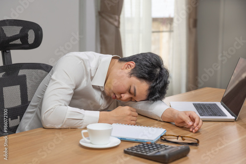 Man with narcolepsy is fall asleep on office desk..Narcolepsy is a sleep disorder that makes people very drowsy during the day.