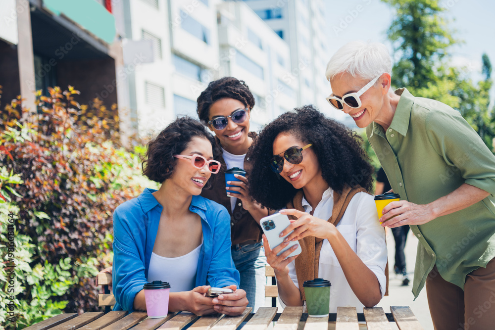 Fototapeta premium Photo of group friends women cafe table smart phone coffee weekend chill street cafe table outdoors