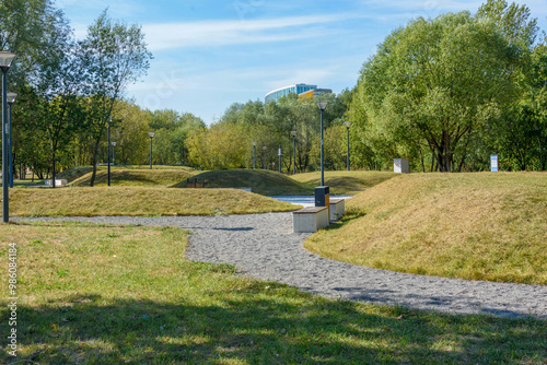 Fototapeta Naklejka Na Ścianę i Meble -  Eco-path made of gravel among artificial hills and lanterns.