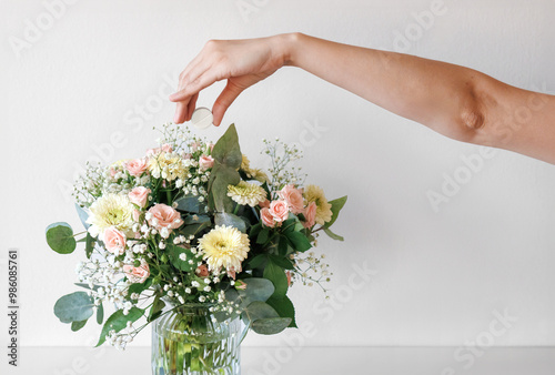 Woman Is Adding A Flower Food Tablet To Fresh Cut Flowers To Help Them Last Longer. Basic of Fresh Flower Care & Handling. photo