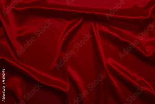 The top view of the red satin surface looks luxurious and beautiful. with sparkling waves Abstract background design copy space Card or banner (blurred or blurry)