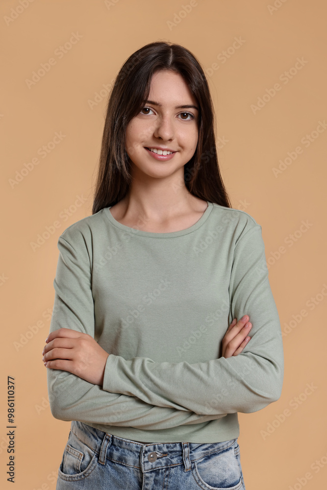 Portrait of cute teenage girl on beige background Portrait of cute teenage girl on beige background